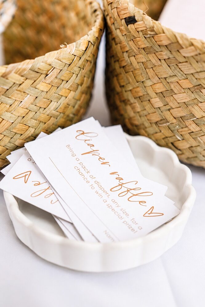 Diaper raffle cards in a scalloped dish